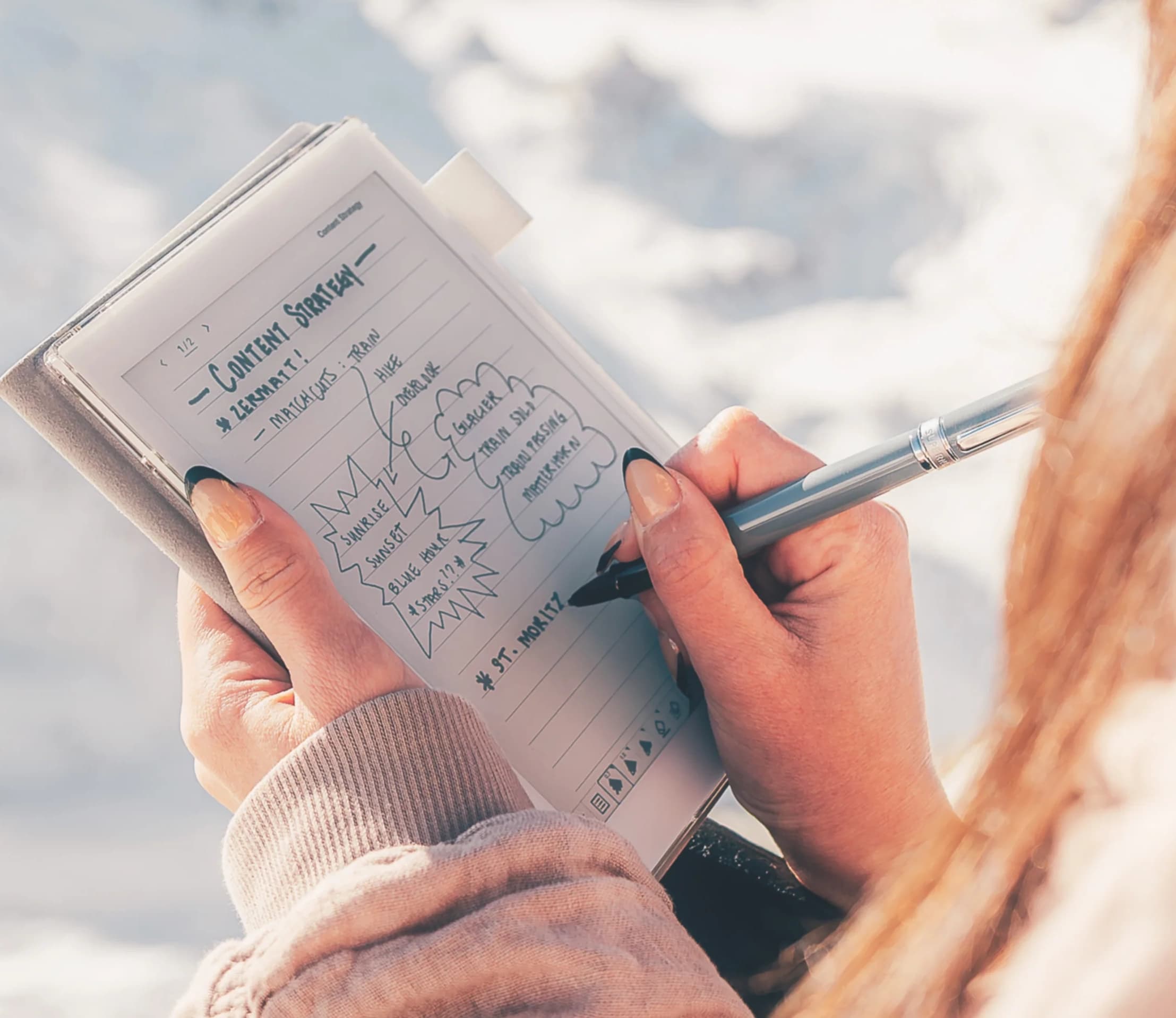 A Supernote Nomad e-ink tablet held in one hand